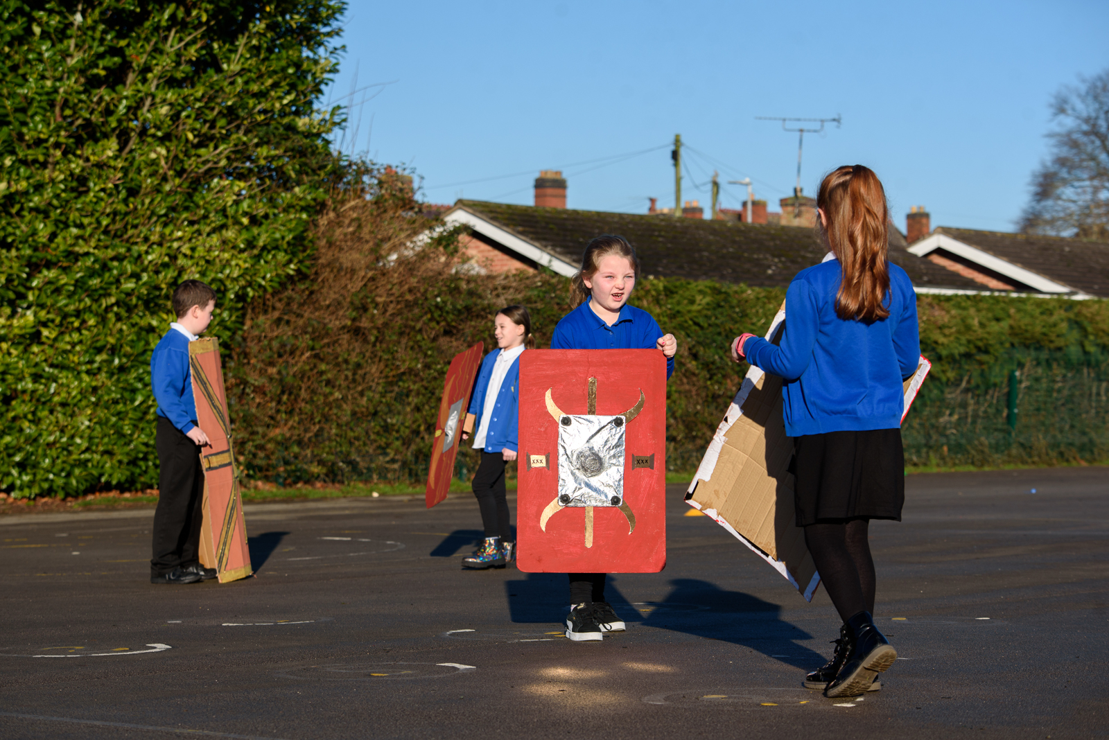 A photograph of children carrying Roman swords